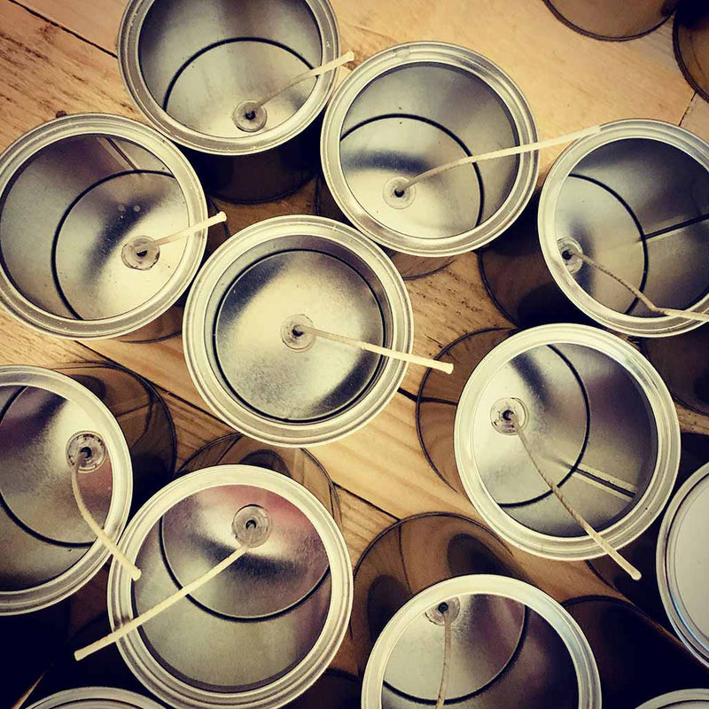 Empty tins ready for candle making class in Malta